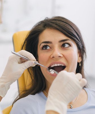 woman getting her mouth examined 