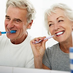 older couple brushing their teeth