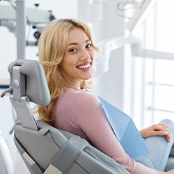 Woman sitting in a dental chair and smiling